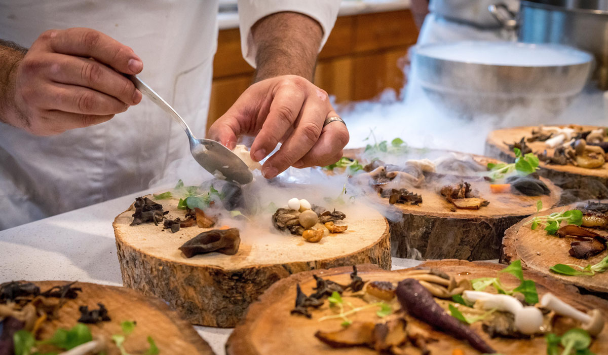 A Chef Prepares Appetizers On Wooden Blocks