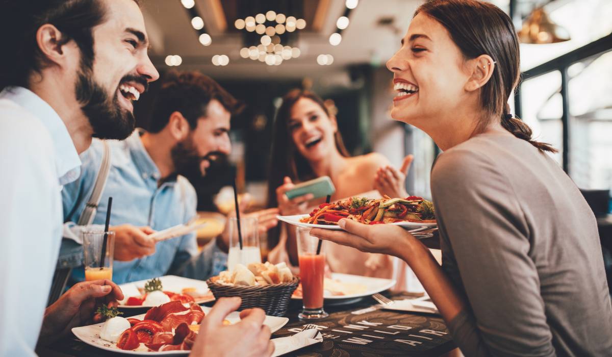 Restaurant customers smiling while having a meal.